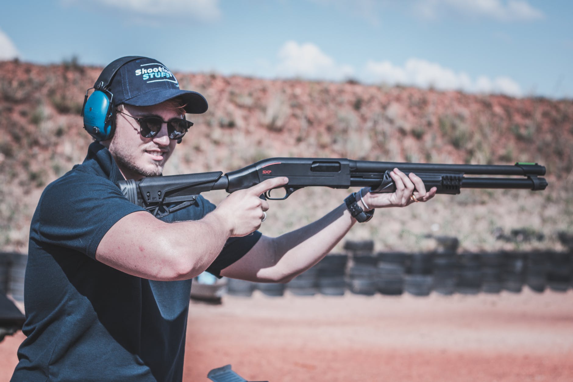photo of man firing shotgun
